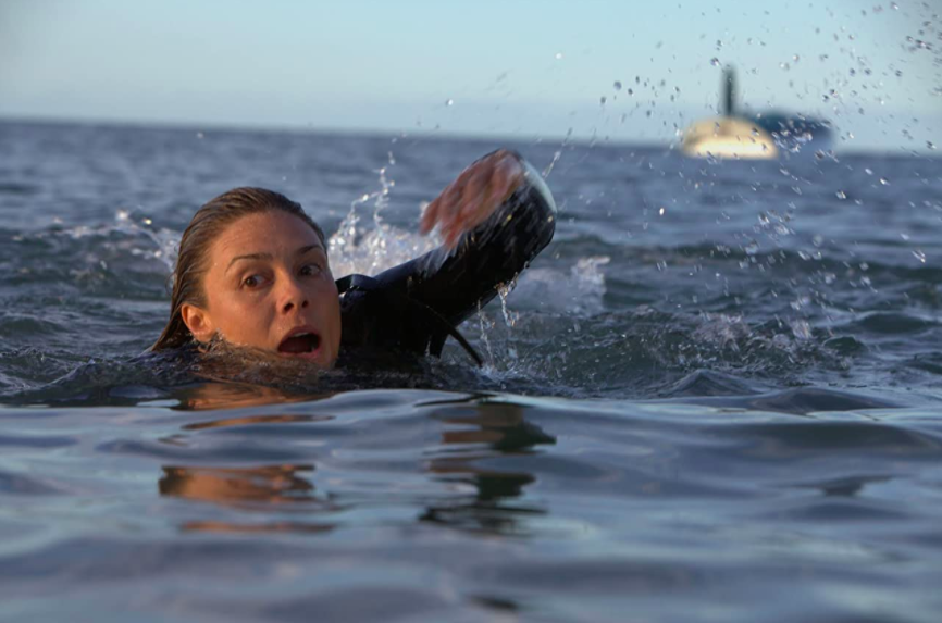 woman swimming away from a shark