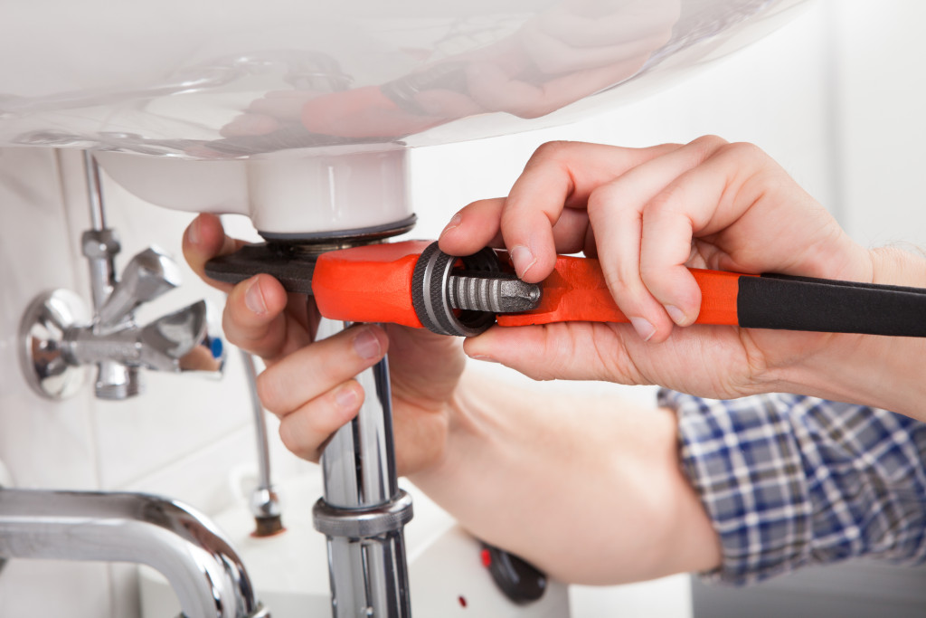 plumbing being fixed by a man