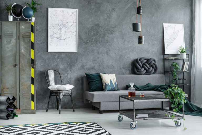 a gray living room with map posters in the wall