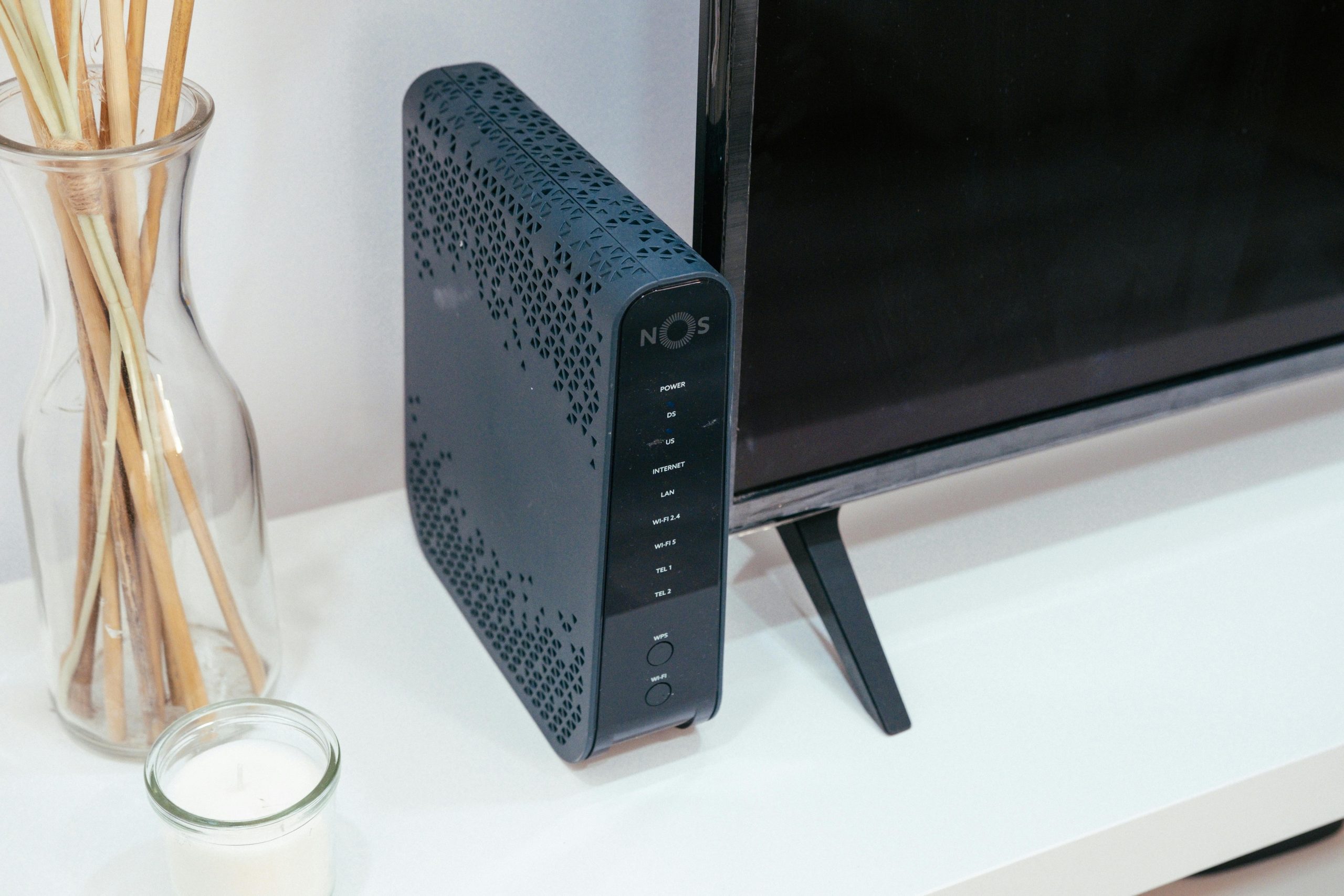 router with a TV and incense sticks next to it